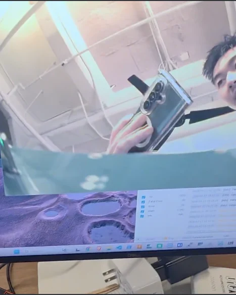 A monitor showing a live feed coming off the team's own camera sensor, with the module held up in front of it